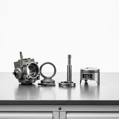 Detailed shot of Kawasaki KX engine components on a clean workbench