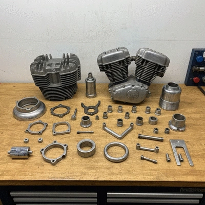 Clean organized motorcycle engine parts on a workbench